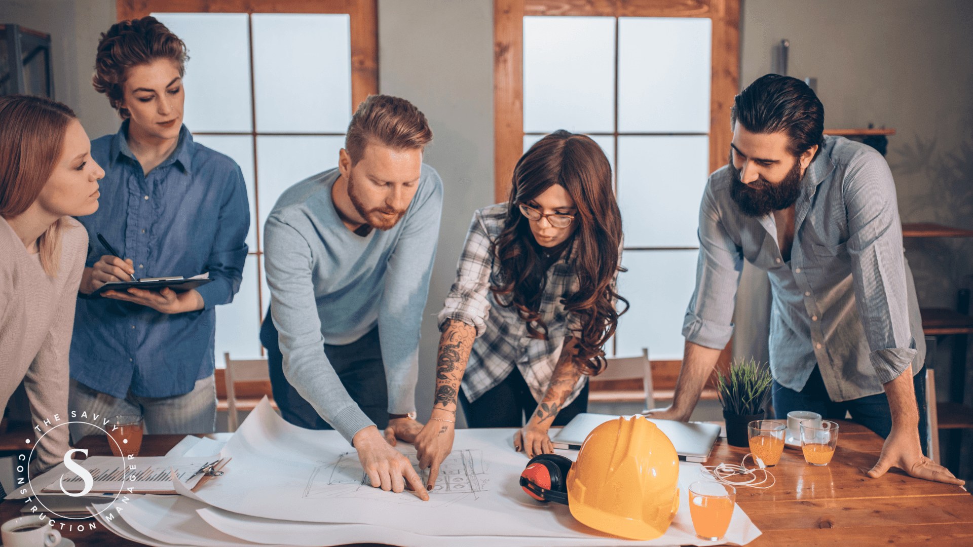 Construction manager discussing blueprints at a project meeting.